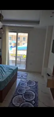 a room with a bed and a rug on the floor at Hurghada Hub in Hurghada