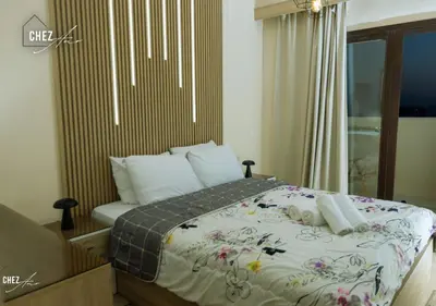 a bedroom with a large bed with flowers on it at Luxury Rooftop Penthouse Sea View & Pools in Hurghada