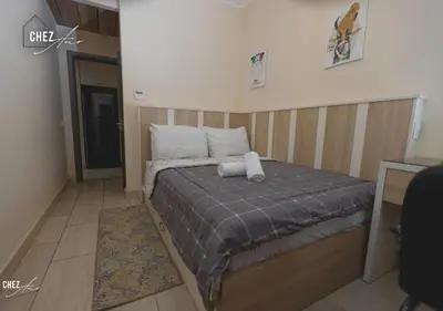 a bedroom with a bed with two pillows on it at Luxury Rooftop Penthouse Sea View & Pools in Hurghada