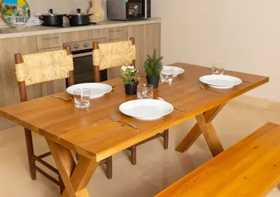 a wooden table with plates on it in a kitchen at Mangroovy Retreat Smart home in Hurghada