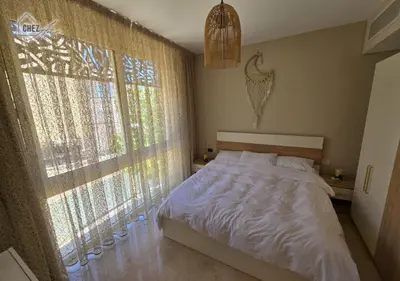 a bedroom with a bed and a large window at Mangroovy Retreat Smart home in Hurghada