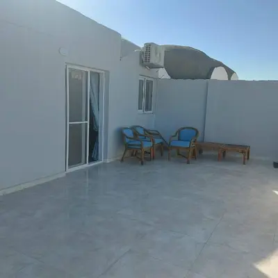 a patio with three chairs and a table and a bench at Veranda SH in Hurghada