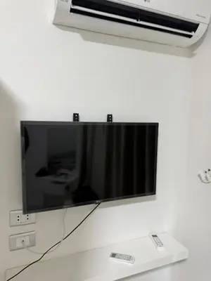 a flat screen tv hanging on a wall at جوليانا الغردقة juliana beach D410 in Hurghada