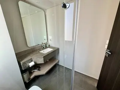 a bathroom with a sink and a mirror at Gouna Ancient Hill 3 BDR Nanny Privat Pool Lagoon View in El Gouna