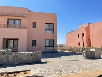 a view of a building with two buildings at Gouna Ancient Hill 3 BDR Nanny Privat Pool Lagoon View in El Gouna