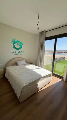 a bedroom with a bed and a large window at Shedwan Twinhouse 3 bedrooms in Hurghada