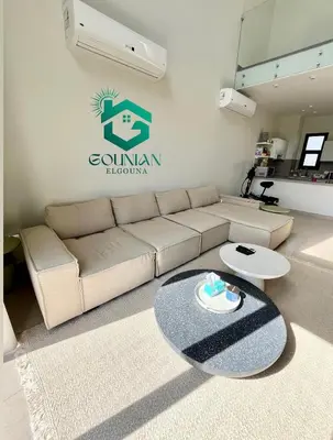 a living room with a couch and a table at Shedwan Twinhouse 3 bedrooms in Hurghada