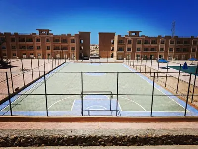 a tennis court in front of a building at Bay view in Hurghada