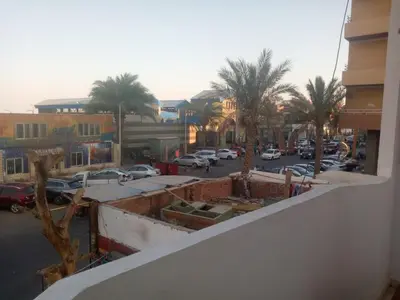 a view of a city street with palm trees and cars at Apartment almina3 in Hurghada