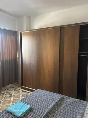 a bedroom with a bed and a wooden wall at Apartment almina3 in Hurghada