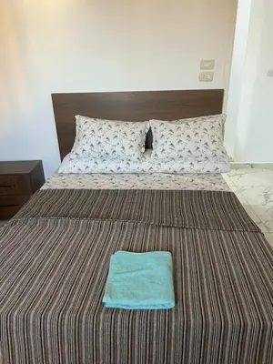 a bed with a blue towel on top of it at Apartment almina3 in Hurghada