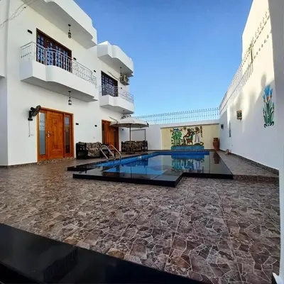 a swimming pool in the middle of a building at Christine Home in Luxor