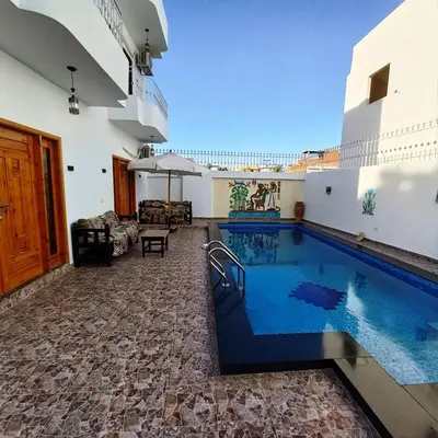 a swimming pool in the middle of a house at Christine Home in Luxor