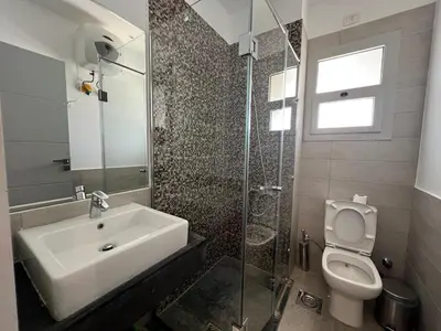 a bathroom with a sink and a toilet at Sholan Gouna | Modern 2BR with Pool Access in Hurghada