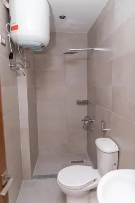 a bathroom with a toilet and a shower at Arkan Hotel Qena in Qena