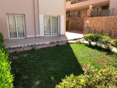 a yard in front of a house with a lawn at Sunset Sahl Hashesh in Hurghada