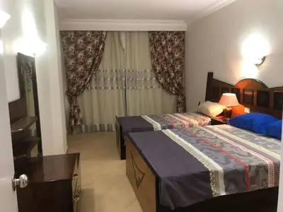 a bedroom with two beds and a window at Sunset Sahl Hashesh in Hurghada