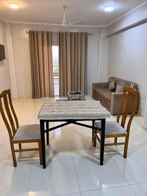 a living room with a table and two chairs at The Nile Paradise in Al Aqālitah