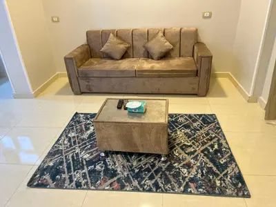 a living room with a couch and a coffee table at The Nile Paradise in Al Aqālitah