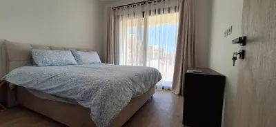 a bedroom with a bed and a large window at El Gouna Paradise Escape 2-Bedroom Ground Floor in El Gouna