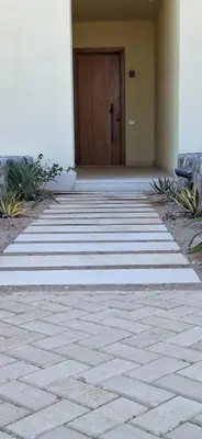 a walkway leading to a door in a building at El Gouna Paradise Escape 2-Bedroom Ground Floor in El Gouna