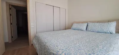 a bedroom with a bed with blue sheets and pillows at El Gouna Paradise Escape 2-Bedroom Ground Floor in El Gouna