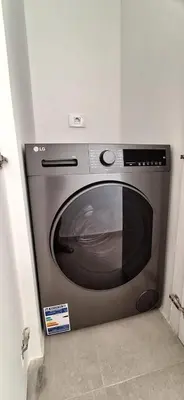 a silver microwave sitting in a corner of a room at El Gouna Paradise Escape 2-Bedroom Ground Floor in El Gouna