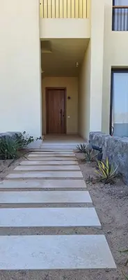 a walkway leading to a door of a building at El Gouna Paradise Escape 2-Bedroom Ground Floor in El Gouna