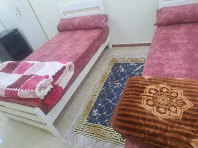 two beds sitting next to each other in a room at Sweet Home 7 in Hurghada