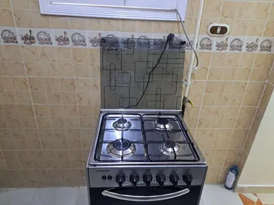 a stove top oven sitting in a kitchen at Sweet Home 7 in Hurghada