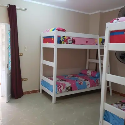 a bedroom with two bunk beds and a bed at Sweet Home Hostel in Hurghada