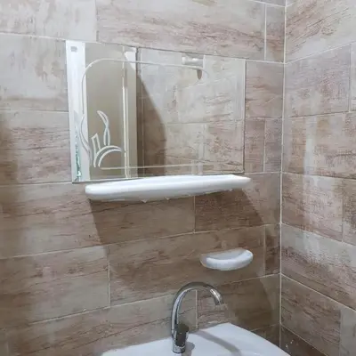 a bathroom with a sink and a mirror on the wall at Sweet Home Hostel in Hurghada