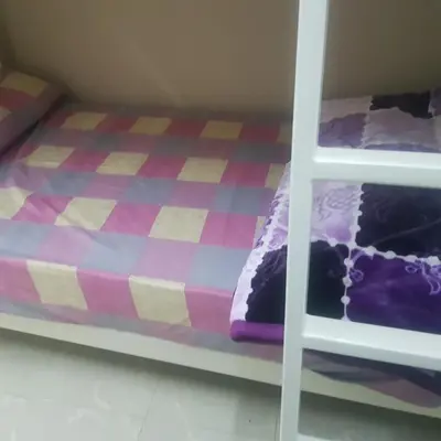 a bunk bed in a room with a purple bed at Sweet Home Hostel in Hurghada