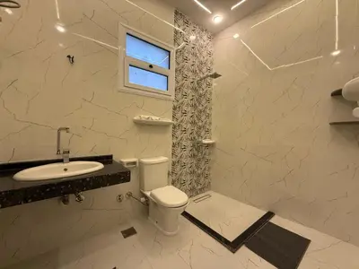 a bathroom with a toilet and a sink and a window at Nefertarie Villa in Luxor