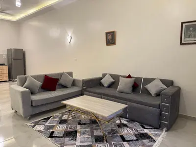 a living room with a couch and a coffee table at Nefertarie Villa in Luxor