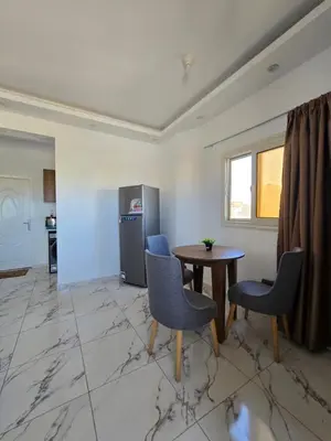 a living room with a table and chairs at الغردقة in Hurghada