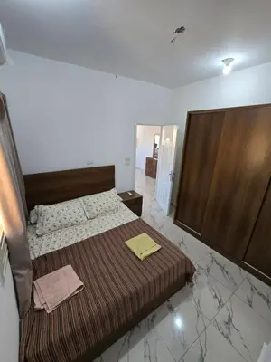 a bedroom with a bed with a wooden headboard at الغردقة in Hurghada