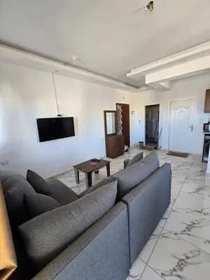 a living room with a couch and a flat screen tv at الغردقة in Hurghada