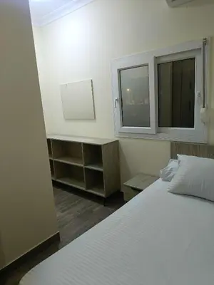 a bedroom with a white bed and a window at Aldora residence شقه 3 غرف نوم و2 حمام in Hurghada