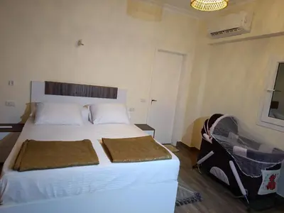 a bedroom with a large white bed in a room at Aldora residence شقه 3 غرف نوم و2 حمام in Hurghada