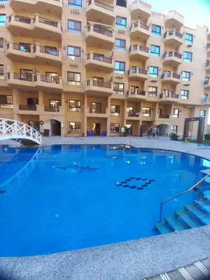 a large swimming pool in front of a building at Turtles Beach Resort, Al Ahyaa in Hurghada