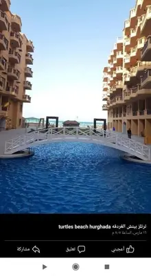 a bridge over the water in front of some buildings at Turtles Beach Resort, Al Ahyaa in Hurghada