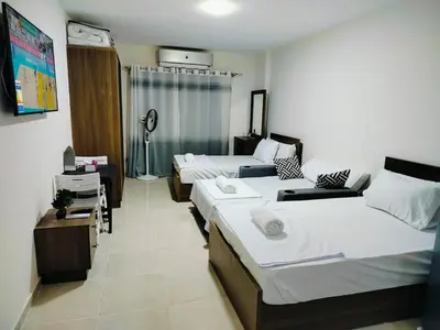 a hotel room with two beds and a couch at Private Beach Chalet in Orabia in Hurghada