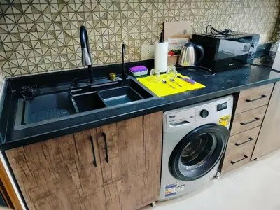 a kitchen with a sink and a washing machine at Private Beach Chalet in Orabia in Hurghada