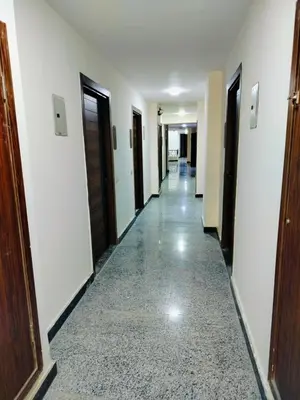 a corridor of a hotel with doors and a floor of tile at Private Beach Chalet in Orabia in Hurghada