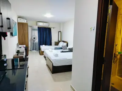 a room with a bed and a living room at Private Beach Chalet in Orabia in Hurghada