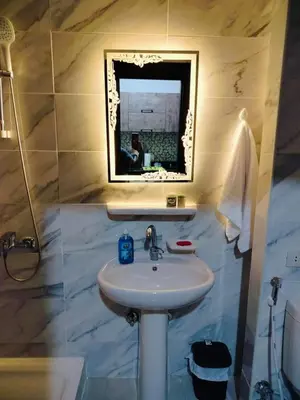a bathroom with a sink and a mirror at Private Beach Chalet in Orabia in Hurghada