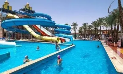 a pool with a water slide at a resort at Veronia gad chalet Mirage bay aqua park in Hurghada