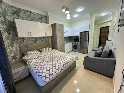 a bedroom with a bed and a couch in it at La-Quinta Resort Erika in Hurghada