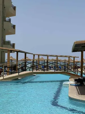 a bridge over a pool of water in a building at La-Quinta Resort Erika in Hurghada